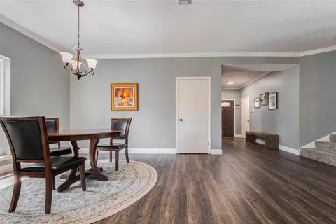 a view of a dining room with furniture and windows