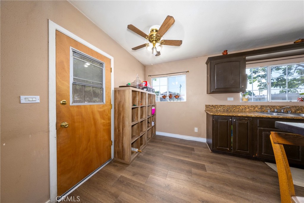 566 South Sage Avenue Rialto, CA 92376 - Photo 12 of 28 a kitchen with stainless steel appliances granite countertop a refrigerator a stove and a sink with wooden floor