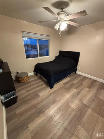 a bedroom with a bed window and a ceiling fan
