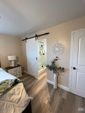a bedroom with a bed and a wooden floor