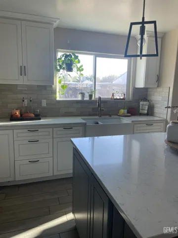 a kitchen with a sink window and cabinets