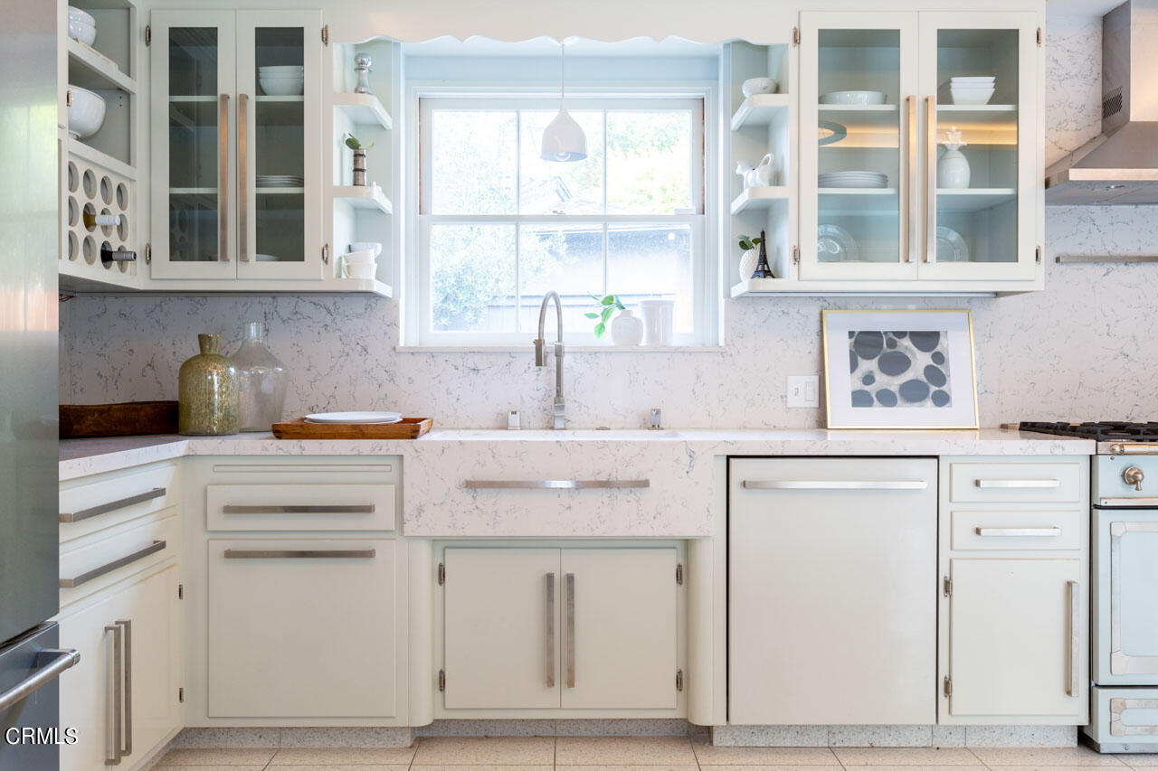 655 Elliott Drive Pasadena, CA 91106 - Photo 15 of 39 a kitchen with white cabinets and a window