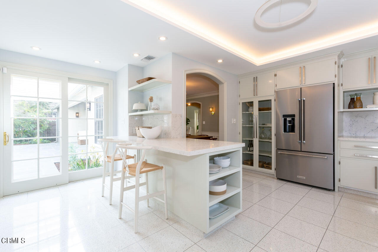 655 Elliott Drive Pasadena, CA 91106 - Photo 17 of 39 a kitchen with stainless steel appliances kitchen island granite countertop a refrigerator and a stove