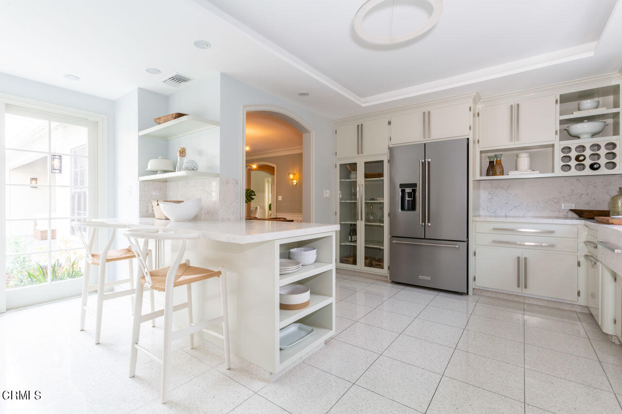 655 Elliott Drive Pasadena, CA 91106 - Photo 18 of 39 a kitchen with white cabinets and stainless steel appliances