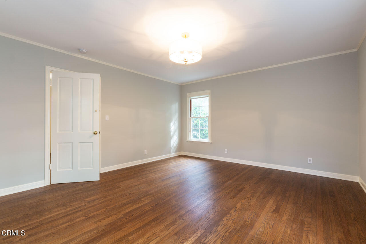 655 Elliott Drive Pasadena, CA 91106 - Photo 32 of 39 a view of an empty room with wooden floor and a window