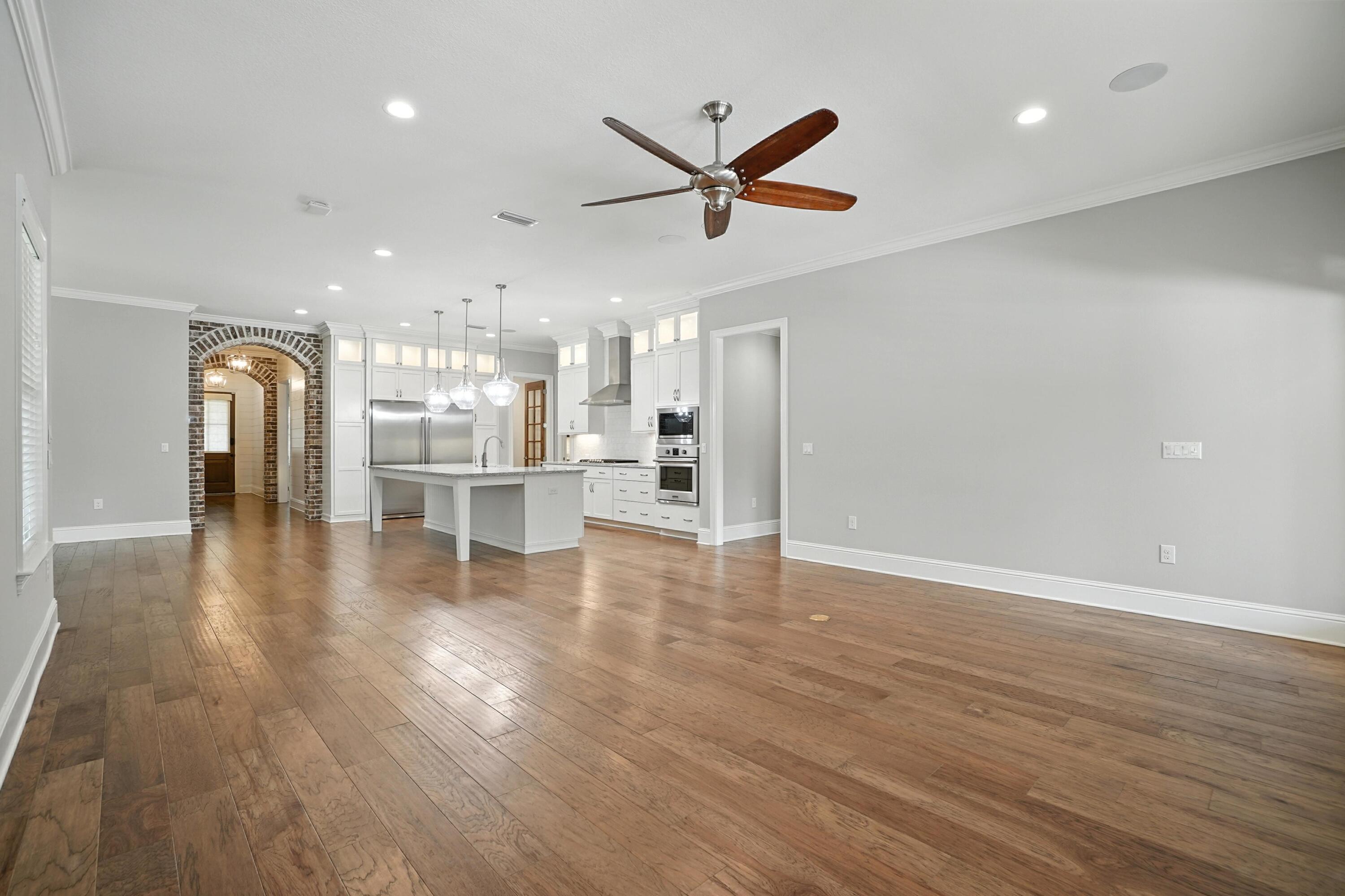 396 Revana Way Freeport, FL 32439 - Photo 13 of 68 a view of a living room a wooden floor and a ceiling fan