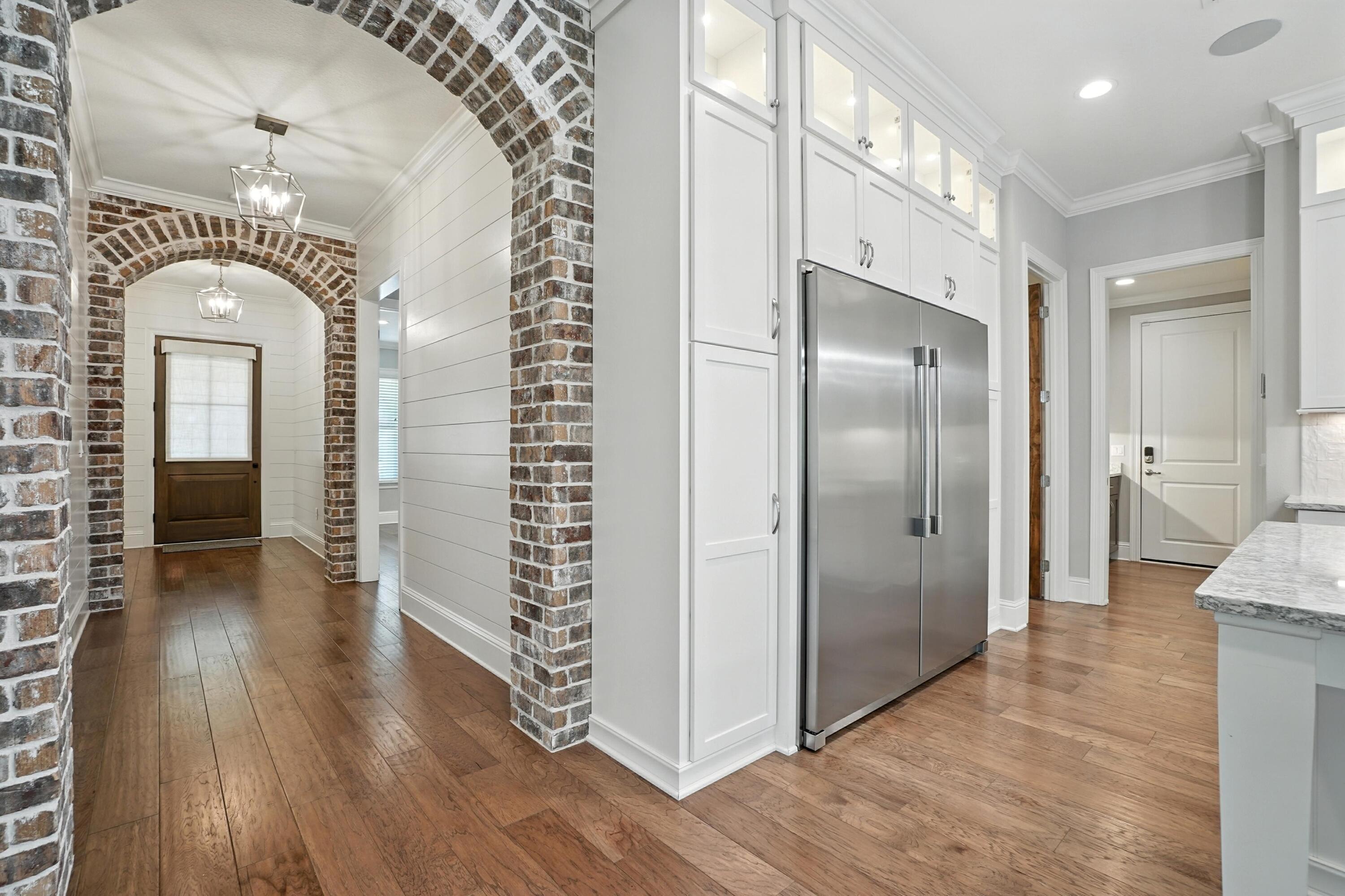 396 Revana Way Freeport, FL 32439 - Photo 15 of 68 a view of a hallway with wooden floor and a living room