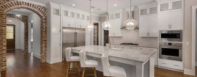 a kitchen with granite countertop a stove and cabinets