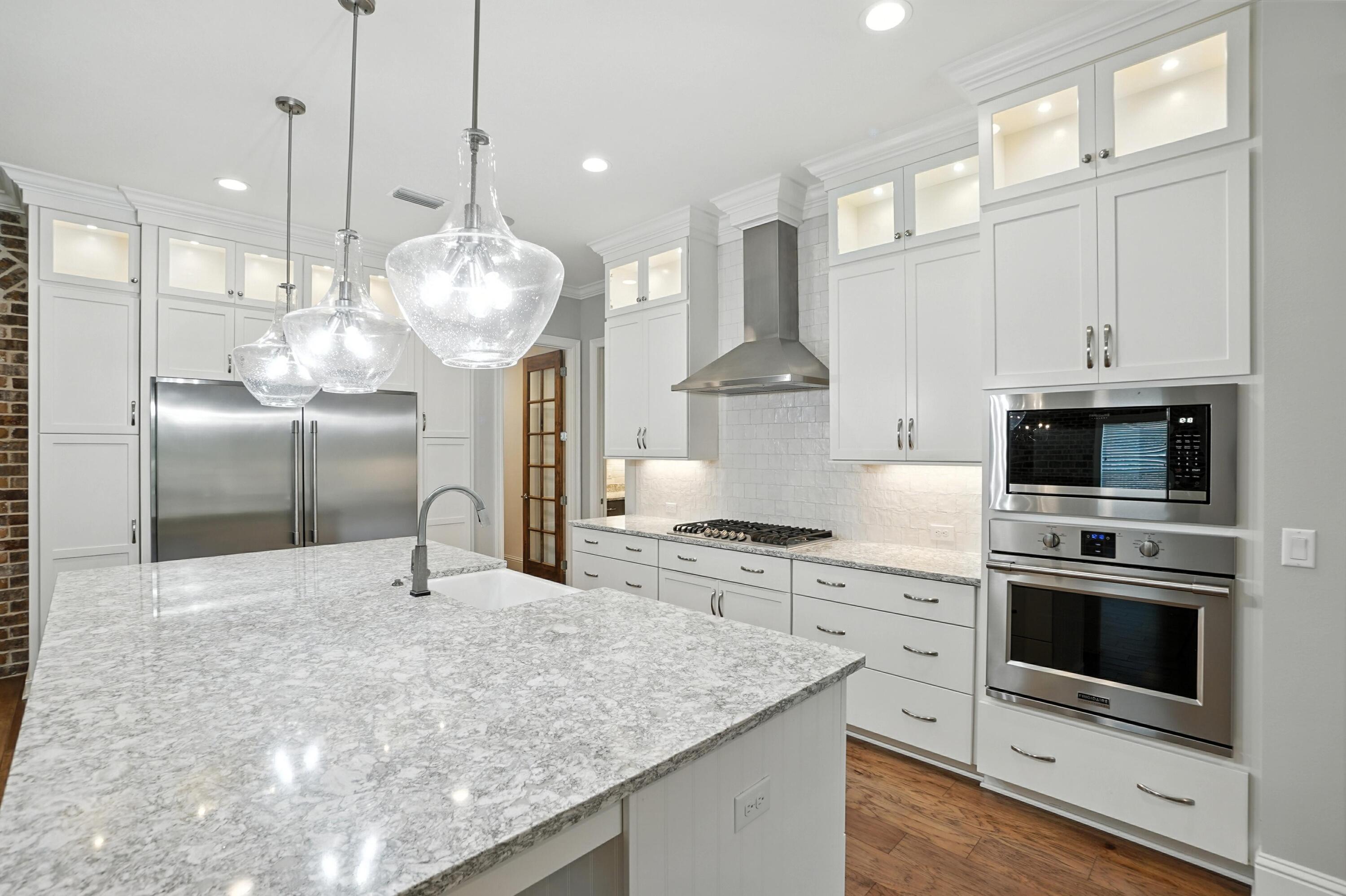 396 Revana Way Freeport, FL 32439 - Photo 18 of 68 a kitchen with stainless steel appliances granite countertop a sink a stove and a refrigerator