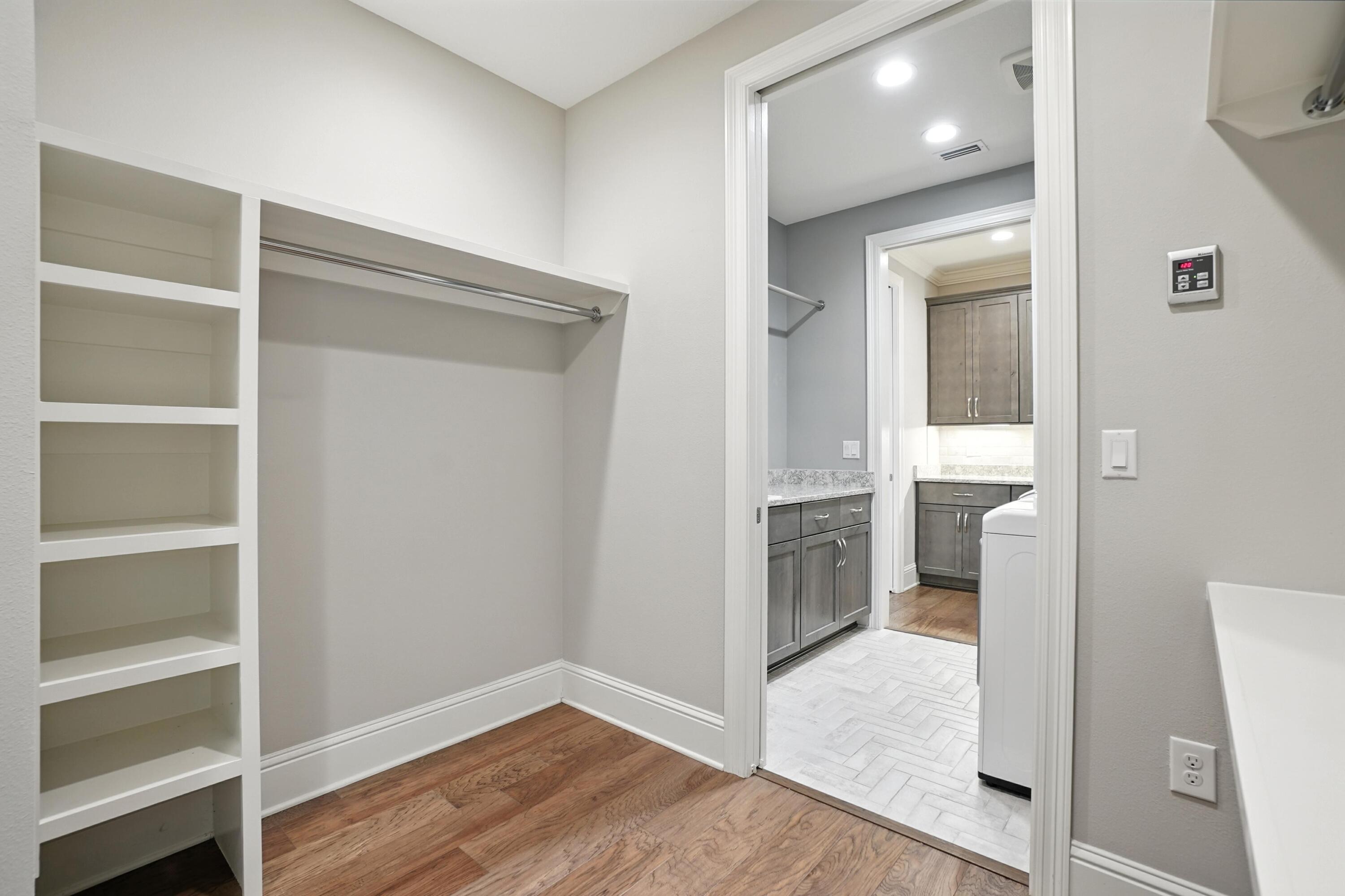 396 Revana Way Freeport, FL 32439 - Photo 35 of 68 a view of hallway with walk in closet and wooden floor
