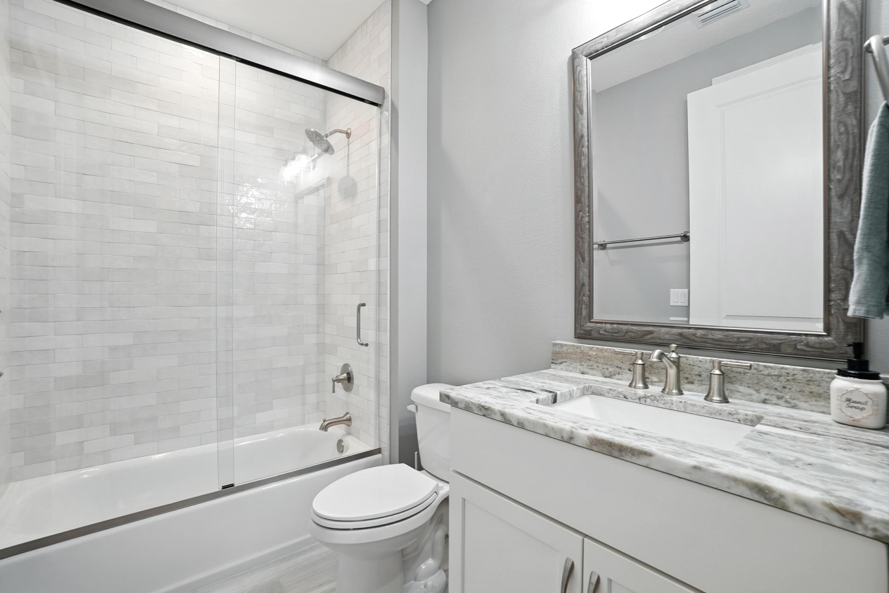 396 Revana Way Freeport, FL 32439 - Photo 38 of 68 a bathroom with a granite countertop sink toilet and shower