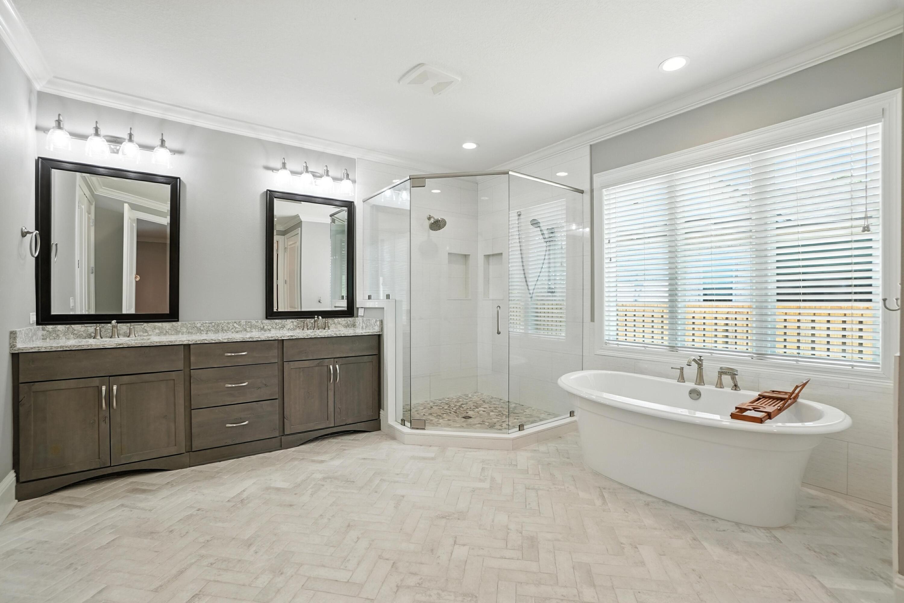 396 Revana Way Freeport, FL 32439 - Photo 39 of 68 a spacious bathroom with double vanity a sink a mirror a bathtub and window