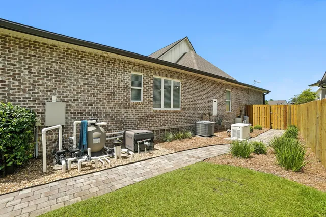 a view of a house with backyard sitting area and garden