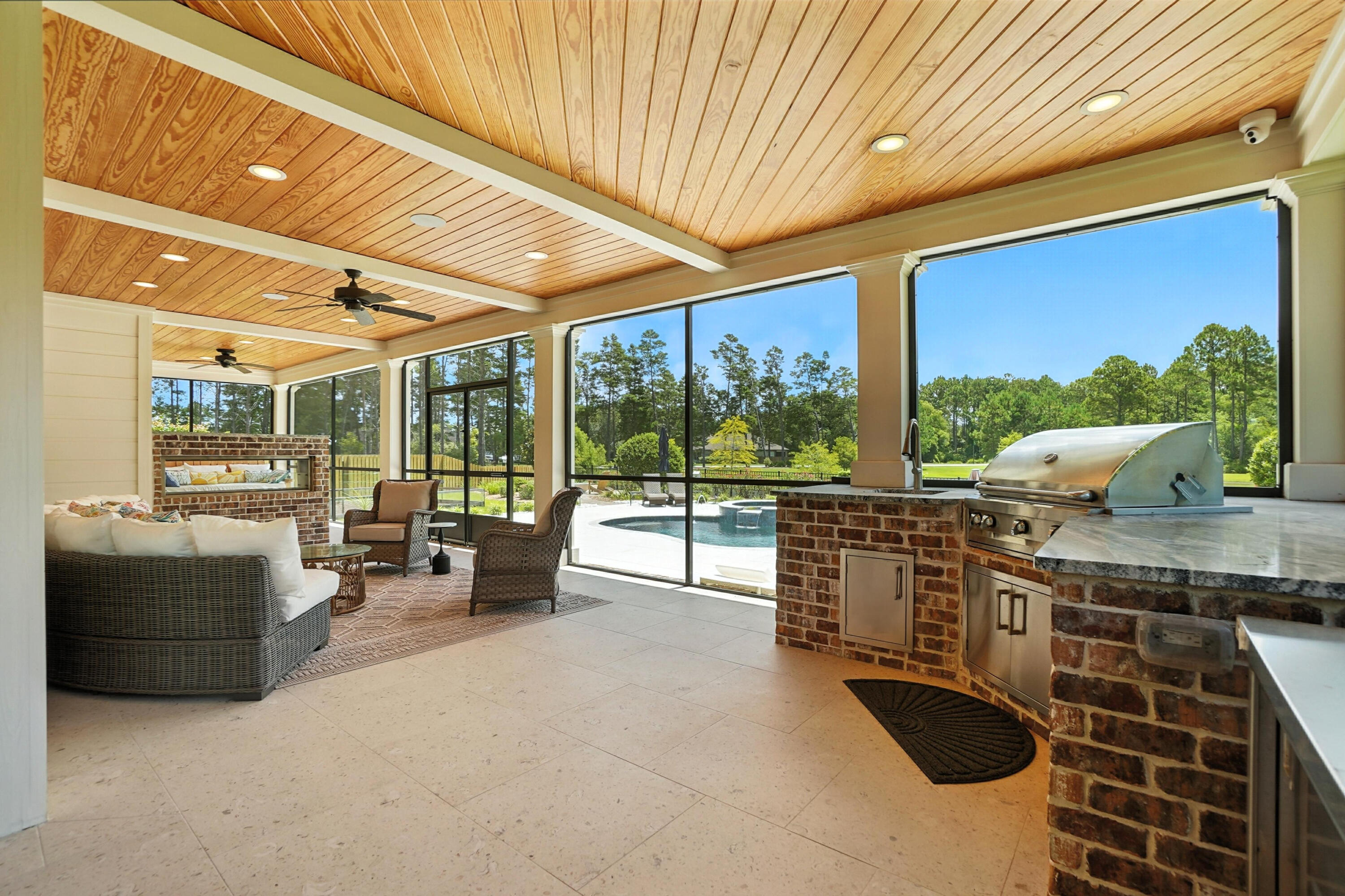 396 Revana Way Freeport, FL 32439 - Photo 49 of 68 a open kitchen with stainless steel appliances granite countertop a barbecue grill and couches with wooden floor