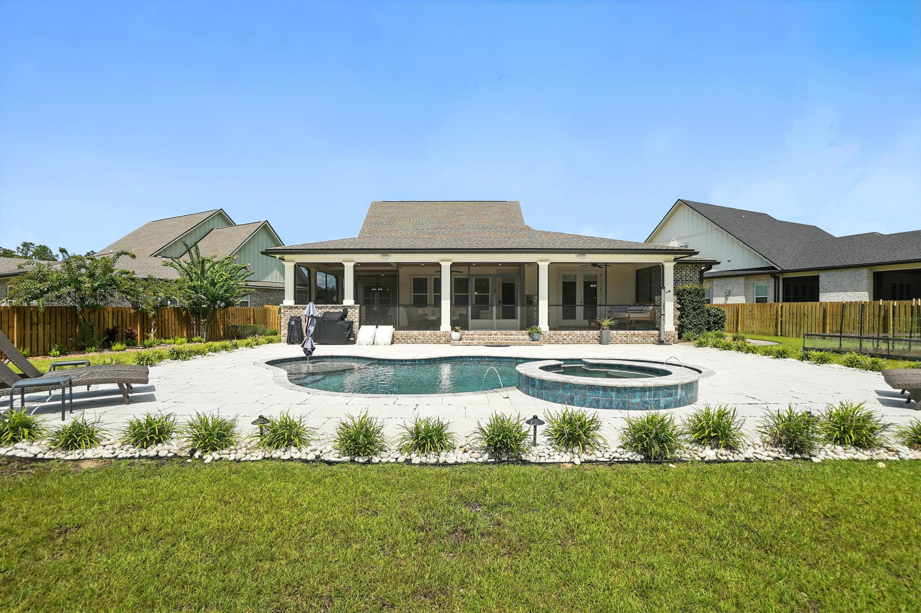 396 Revana Way Freeport, FL 32439 - Photo 60 of 68 a front view of a house with swimming pool and porch with furniture