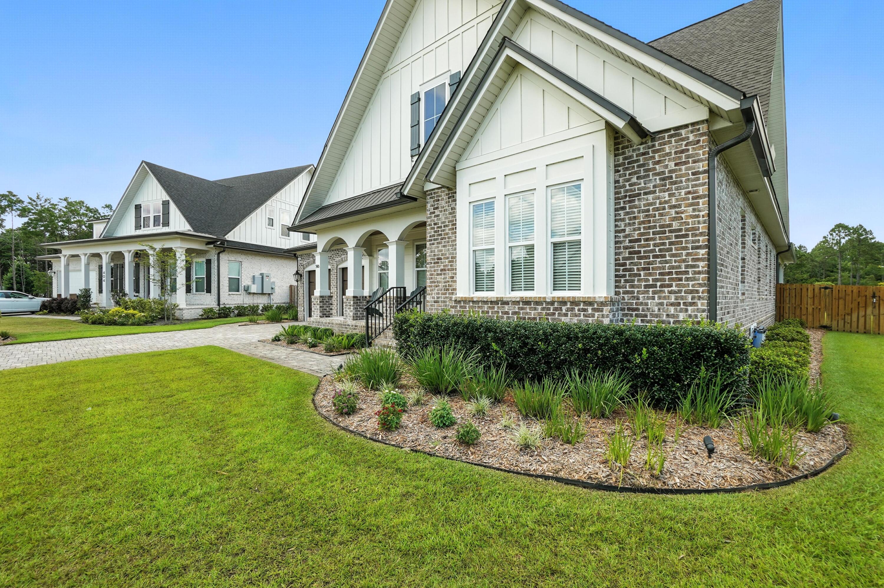 396 Revana Way Freeport, FL 32439 - Photo 6 of 68 a view of a white house with a yard table and chairs