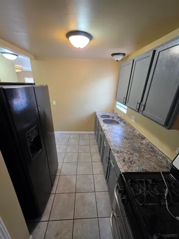 a bathroom with a granite countertop sink a toilet and vanity