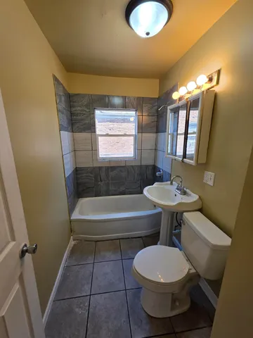 a bathroom with a sink a toilet and bathtub