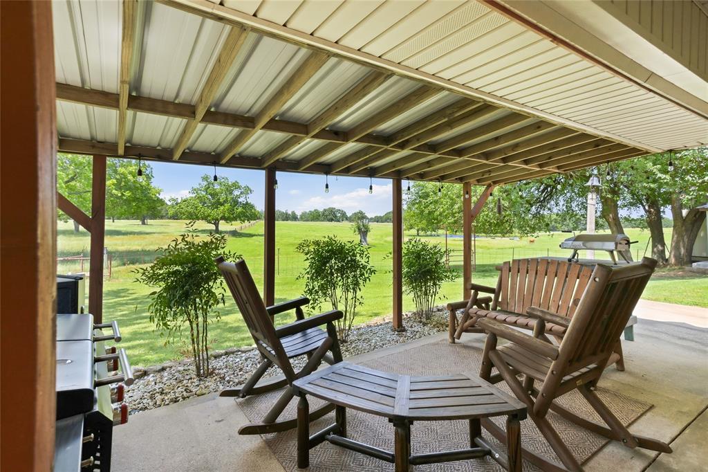 235 Magnus Road Denison, TX 75021 - Photo 28 of 35 a view of patio with a table chairs and a table