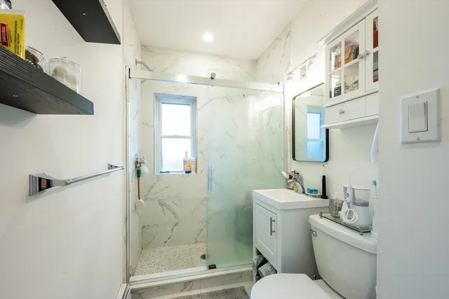 a bathroom with a sink toilet and shower