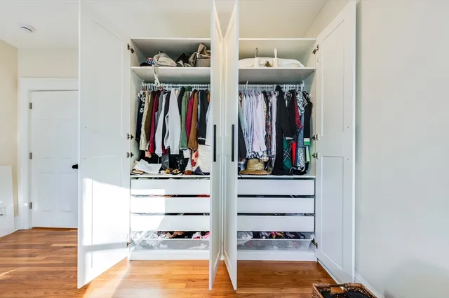 a view of a living room with clothes and shoes