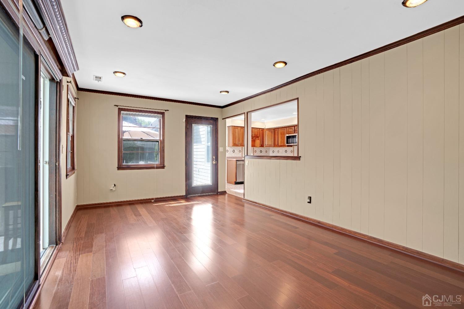 8 Farrington Street Edison, NJ 08820 - Photo 10 of 36 a view of an empty room with a window and wooden floor