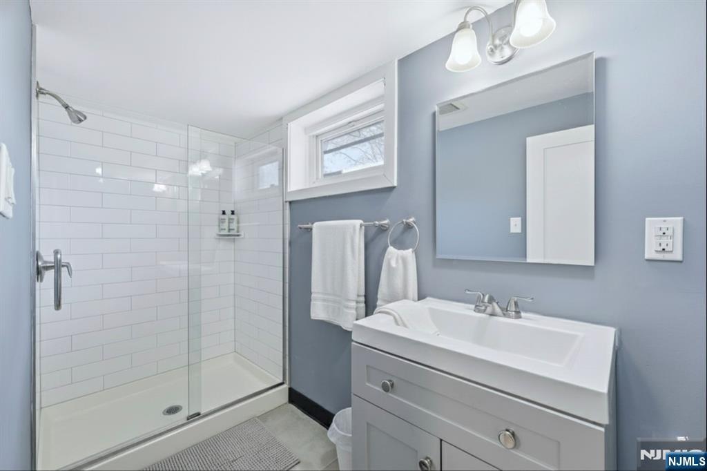 1210 Field Avenue Plainfield, NJ 07060 - Photo 17 of 25 a bathroom with a shower a sink and mirror