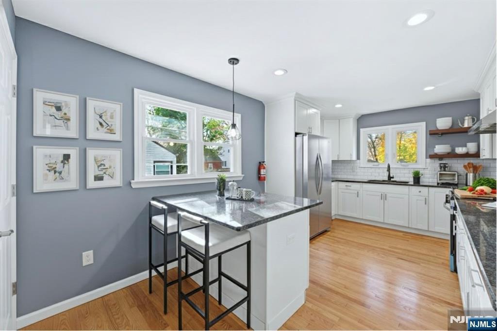 1210 Field Avenue Plainfield, NJ 07060 - Photo 5 of 25 a kitchen with stainless steel appliances granite countertop a stove a sink dishwasher and a refrigerator with wooden floor