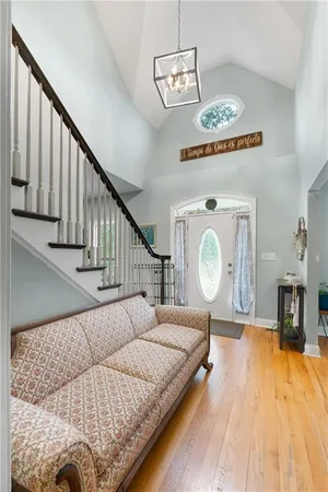 a living room with furniture a fireplace a flat screen tv and a large window