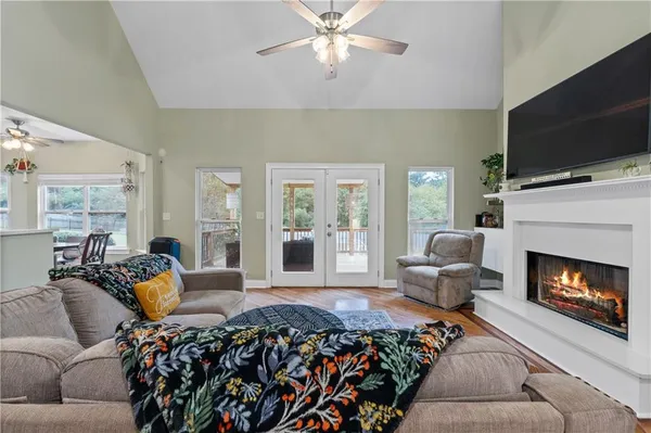 a bedroom with a large bed a flat screen tv and a couch