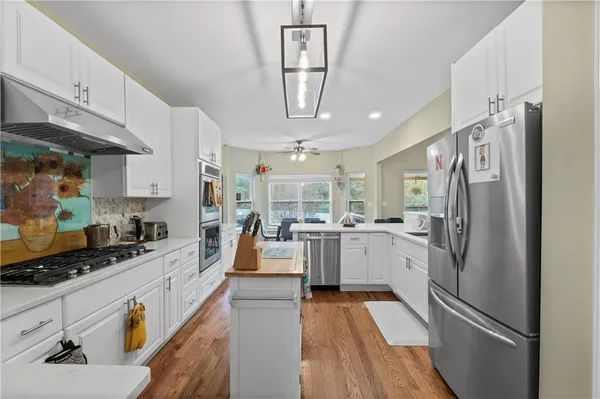 a spacious bathroom with a double vanity sink a large mirror and a shower