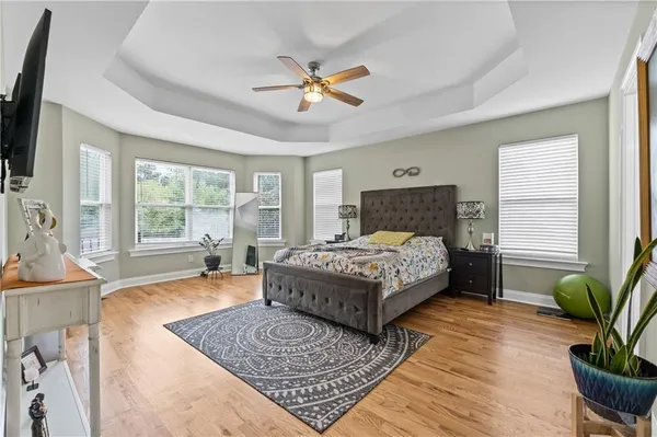 a bathroom with a granite countertop sink toilet and a mirror