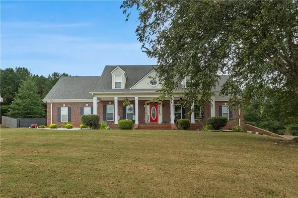 a front view of house with yard and green space