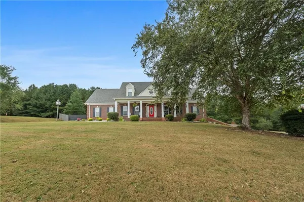 a front view of a house with a garden