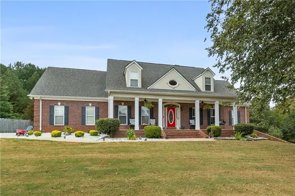 a front view of house with yard and green space