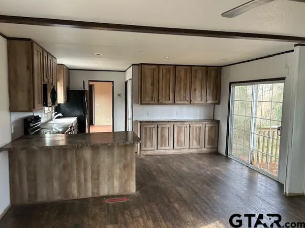 a kitchen with stainless steel appliances granite countertop a refrigerator a sink and a stove