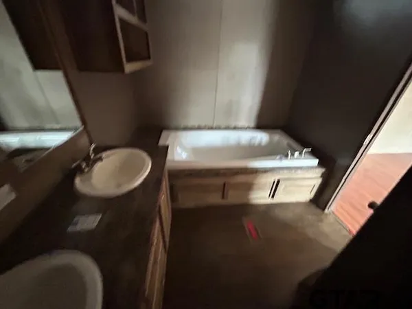 a bathroom with a sink toilet and a mirror