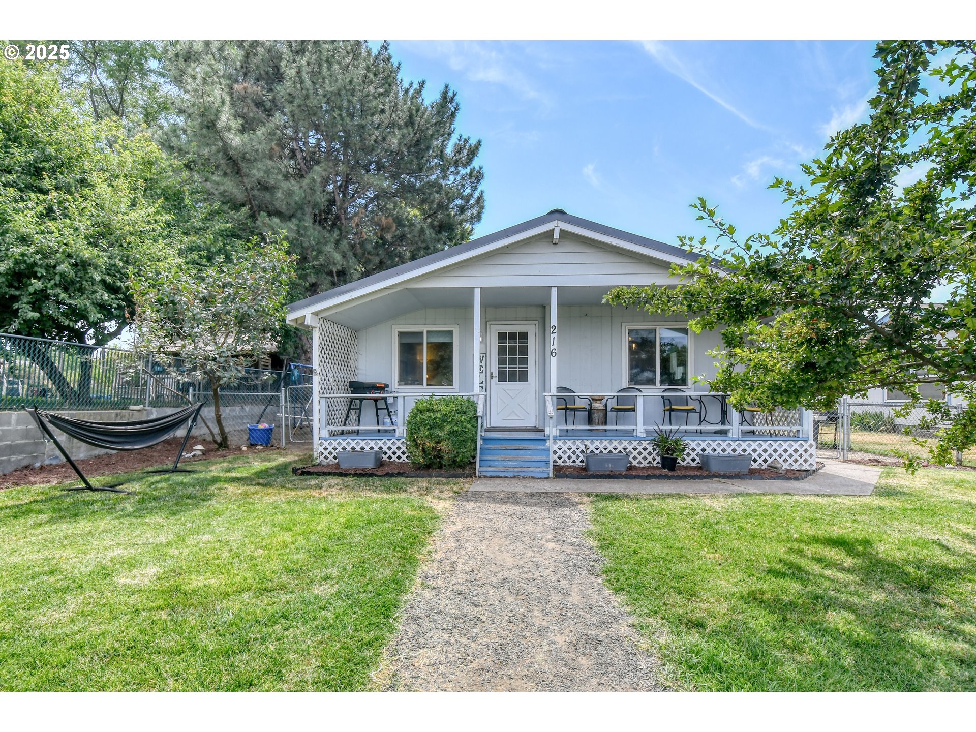 a view of a house with a yard and sitting area