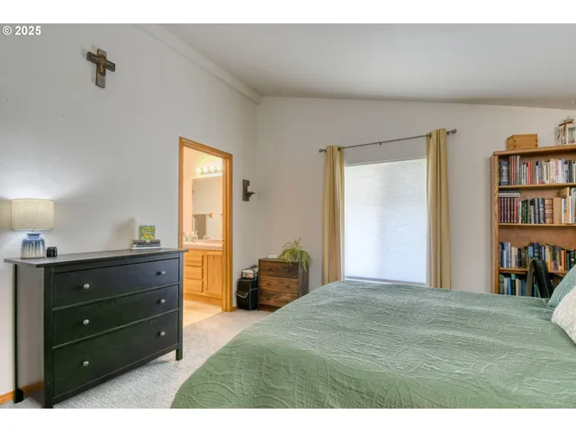 a bedroom with a bed and a bookshelf