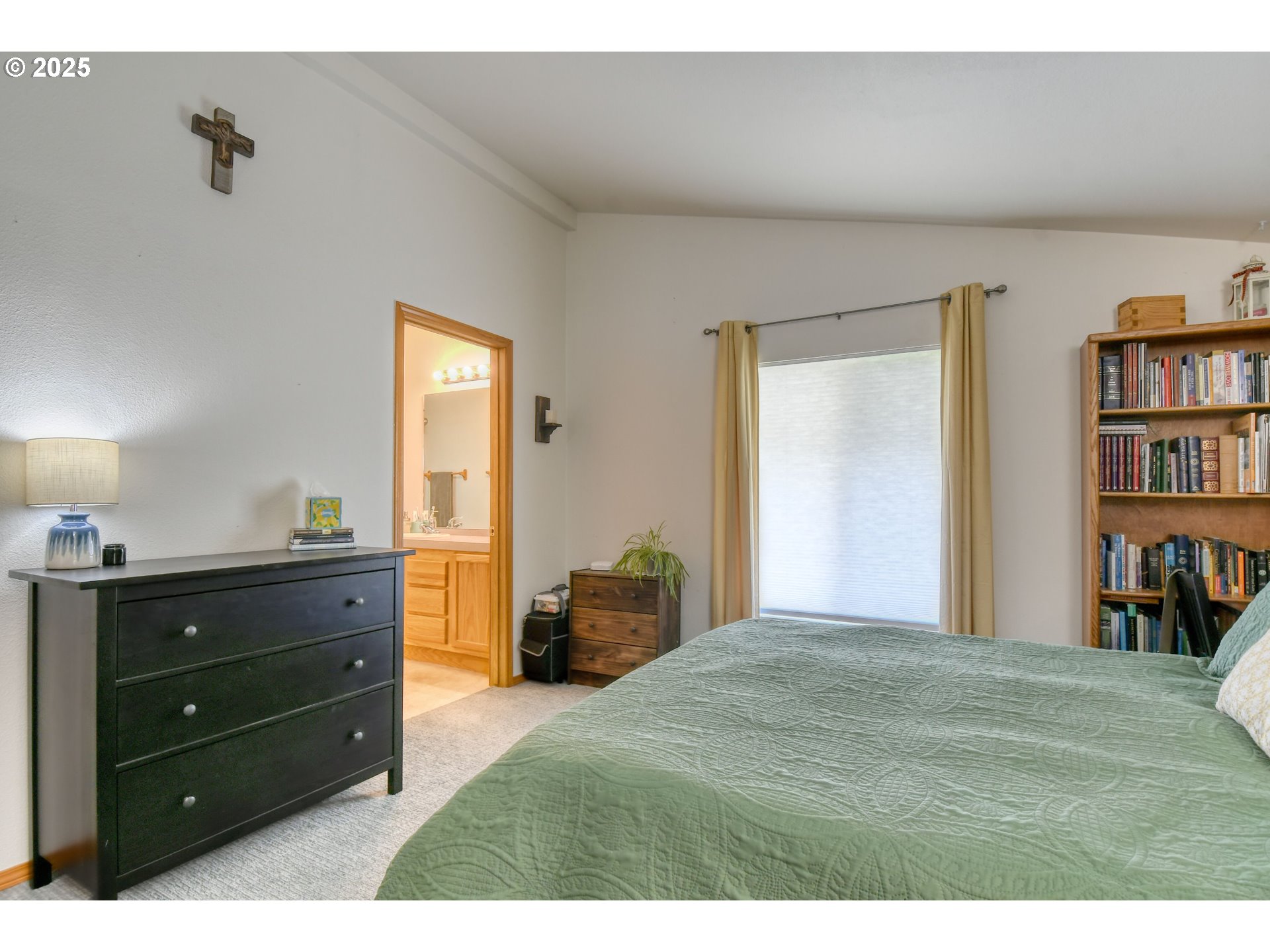216 East Washington Street Athena, OR 97813 - Photo 13 of 27 a bedroom with a bed and a bookshelf