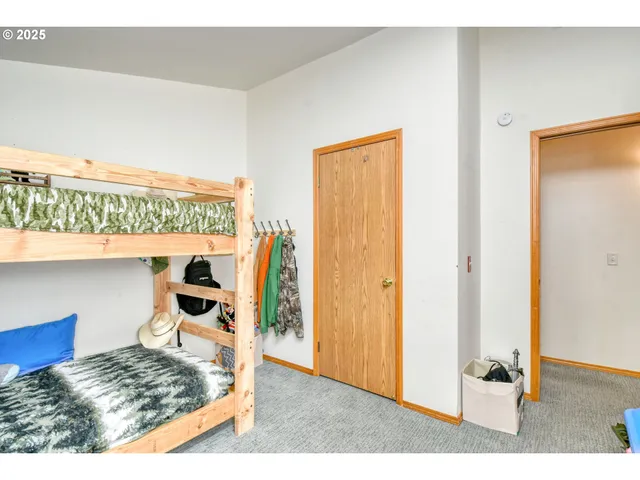 a living room with a bed and a dresser