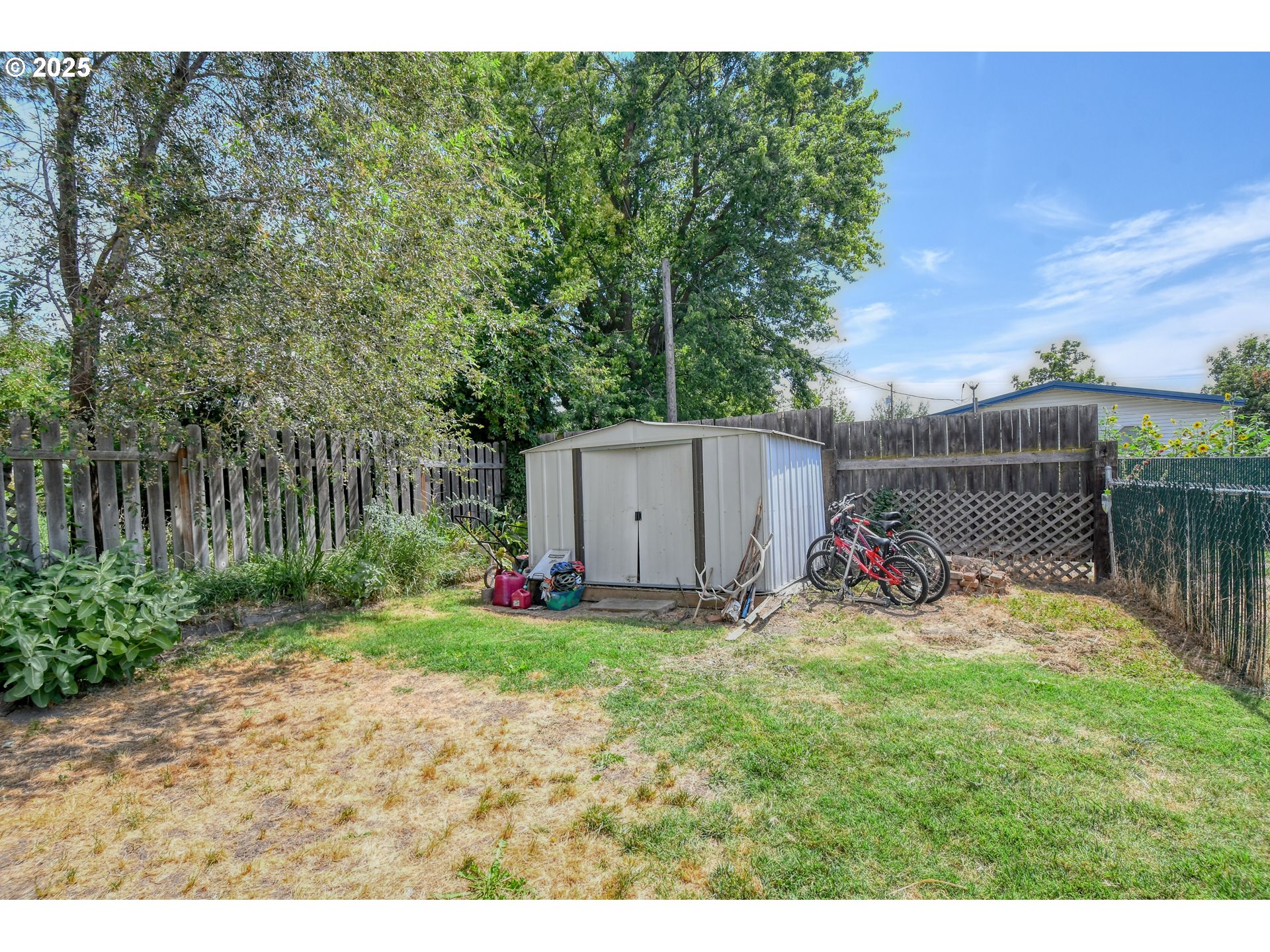 216 East Washington Street Athena, OR 97813 - Photo 25 of 27 a view of a backyard with plants and a bench