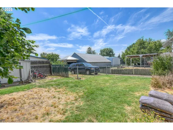 a backyard of a house with table and chairs