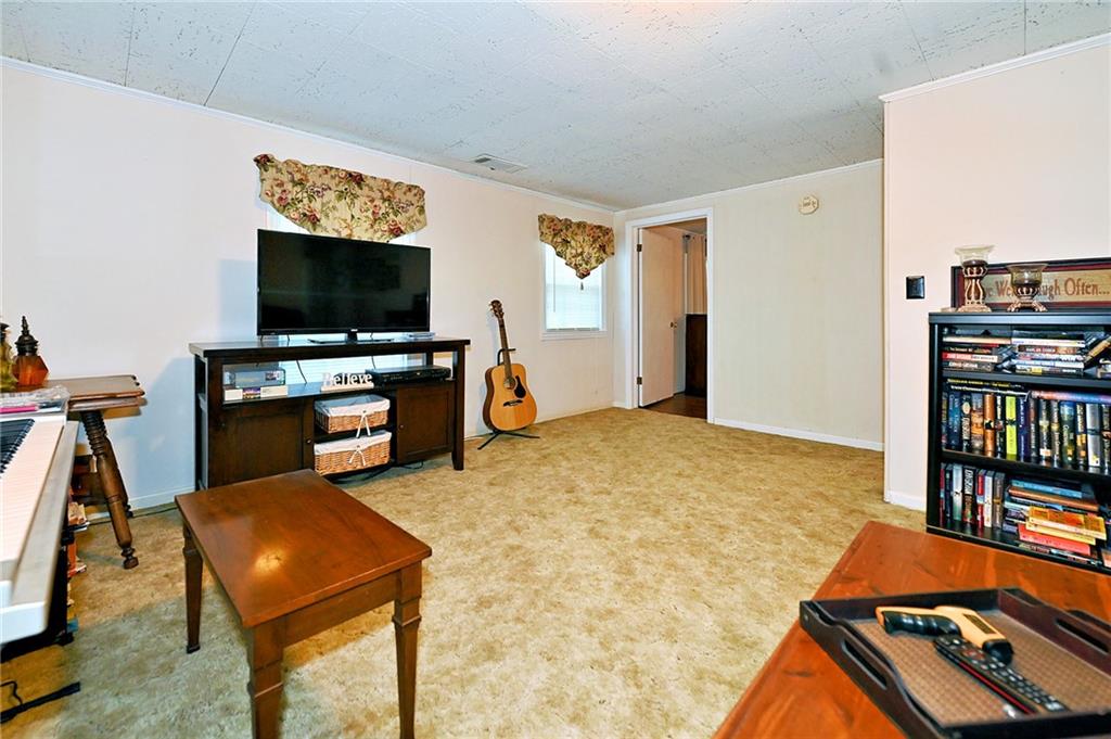 5937 Thompson Bridge Road Murrayville, GA 30564 - Photo 24 of 54 a living room with furniture and a flat screen tv