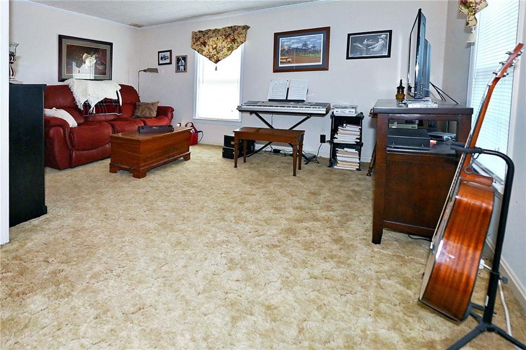 5937 Thompson Bridge Road Murrayville, GA 30564 - Photo 25 of 54 a living room with furniture a rug and a piano