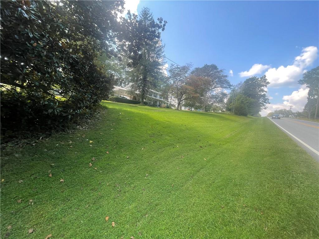 5937 Thompson Bridge Road Murrayville, GA 30564 - Photo 49 of 54 a view of a field of grass and trees