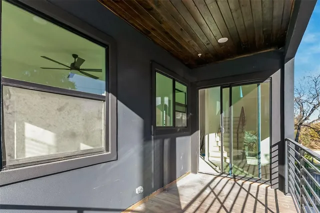 a living room with furniture and a ceiling fan
