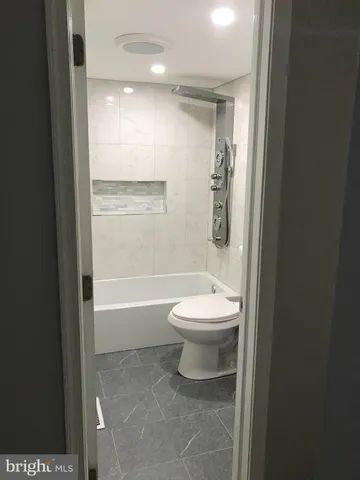 a bathroom with a toilet a sink and shower