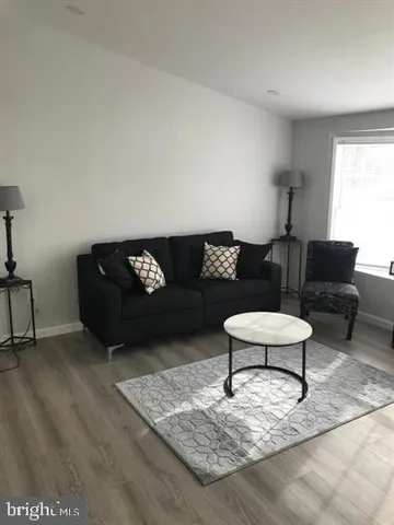 a living room with furniture and a rug