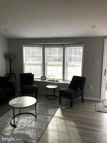 a living room with furniture a rug and a window